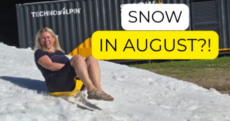 Woman sledding on snow in the Krkonoše Mountains on a hot summer day in August